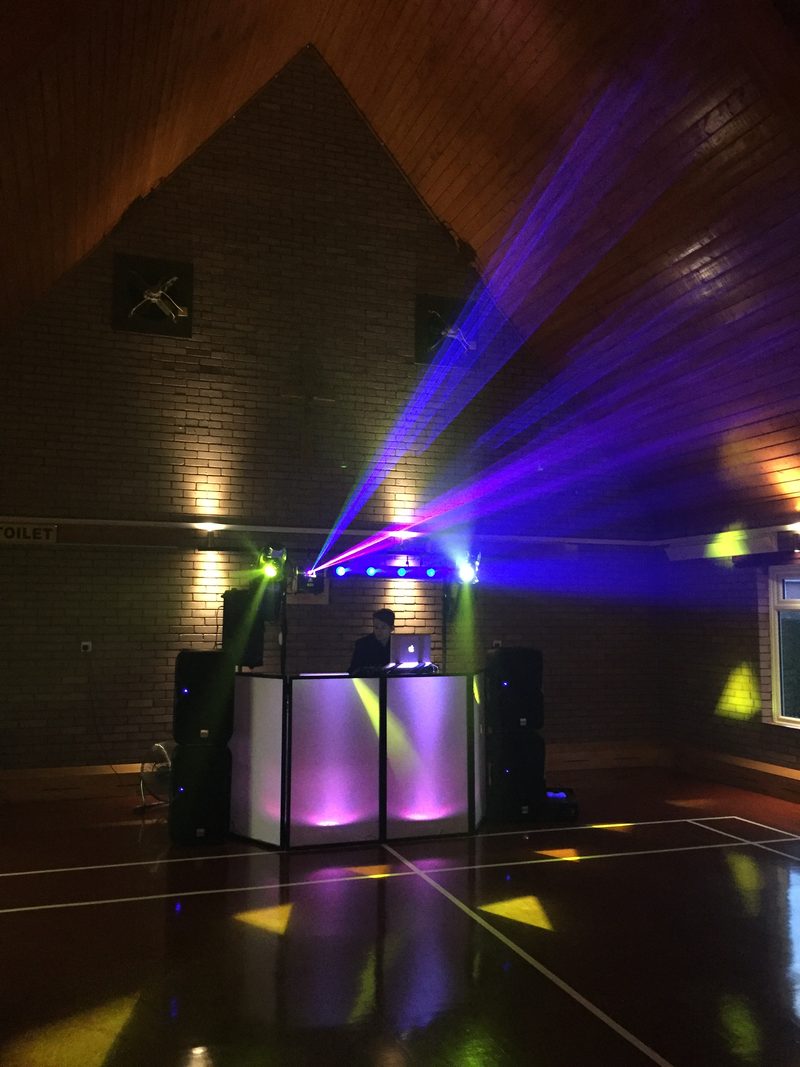 DJ Terry Seager's DJ booth with purple and green lighting