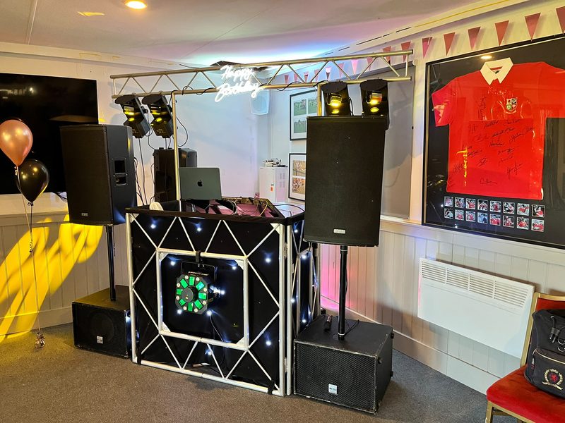 DJ Terry Seager's full DJ setup with speakers and lighting at a party venue